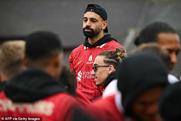 Mohamed Salah wore his cap backwards as the rain poured down on the streets of Liverpool