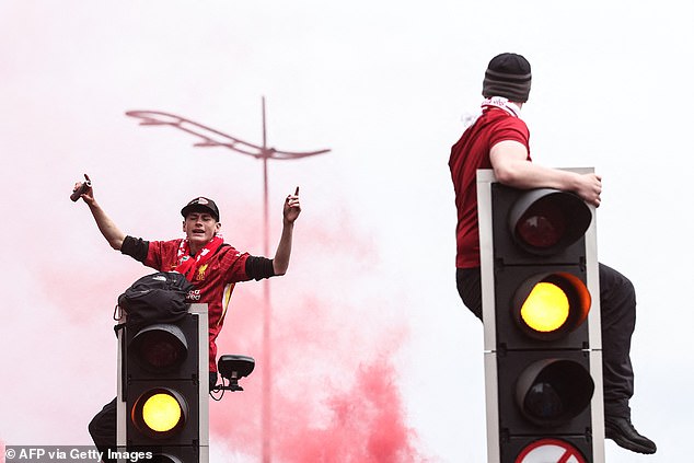 Some supporters climbed traffic lights as a number of roads were closed in the city on Monday