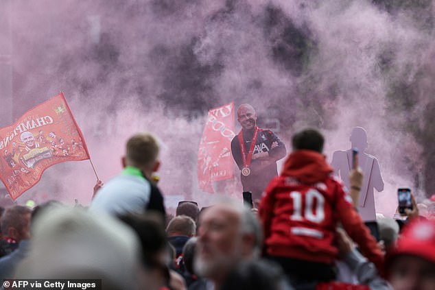 Cardboard cutouts of Arne Slot were also seen, with fans letting off flares early on