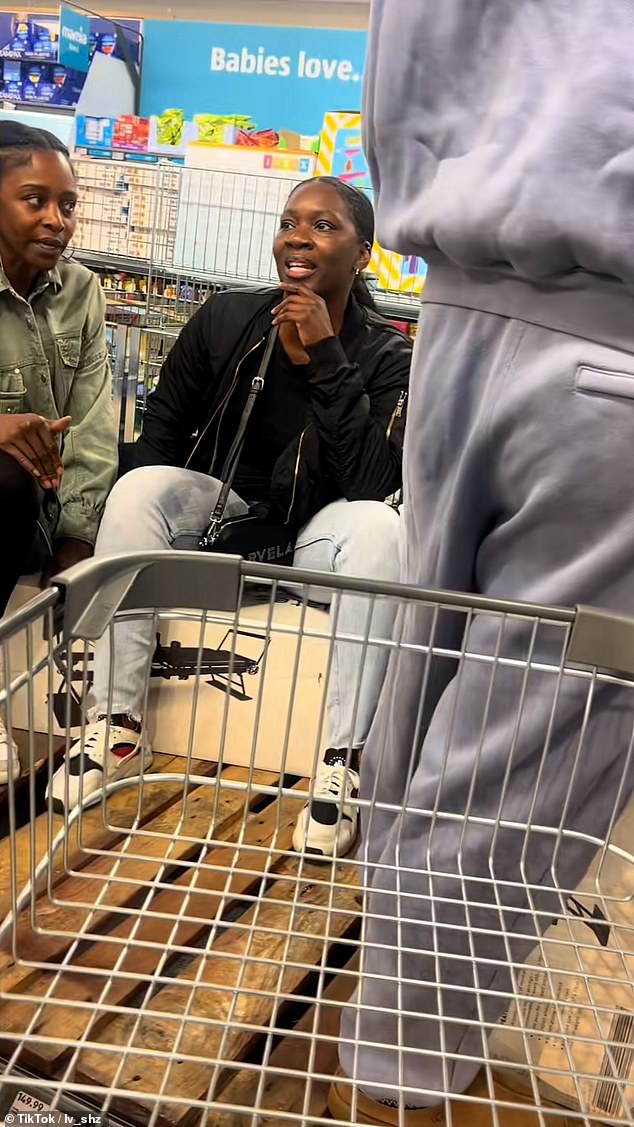 One shopper was seen sitting on boxes inside the unidentified Aldi store in London