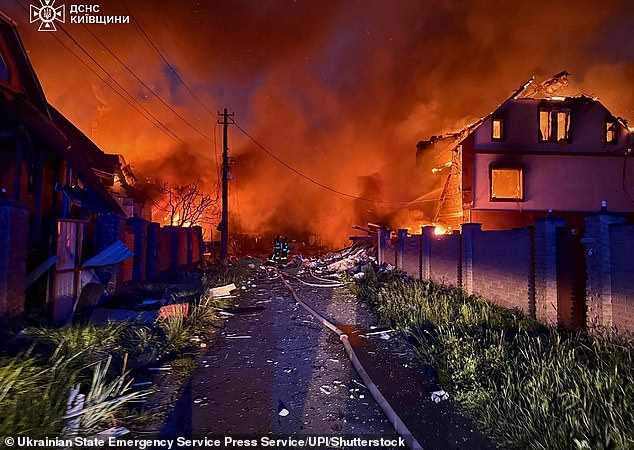 Burning houses are seen after a devastating Russian air strike on a town in the Kyiv region