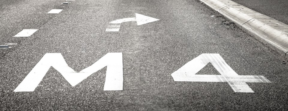 Road marking indicating M4 and a right turn.