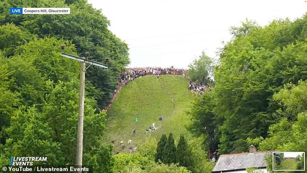 This year's competitors have been seen tumbling the 180m-tall hill in pursuit of the 3kg cheese