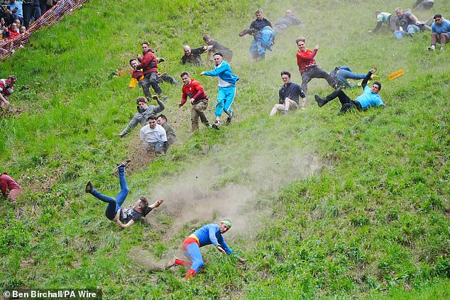 The first runners to catch the cheese, which can reach speeds of up to 70mph, are declared victors in various races across the event that dates back to the 1800s