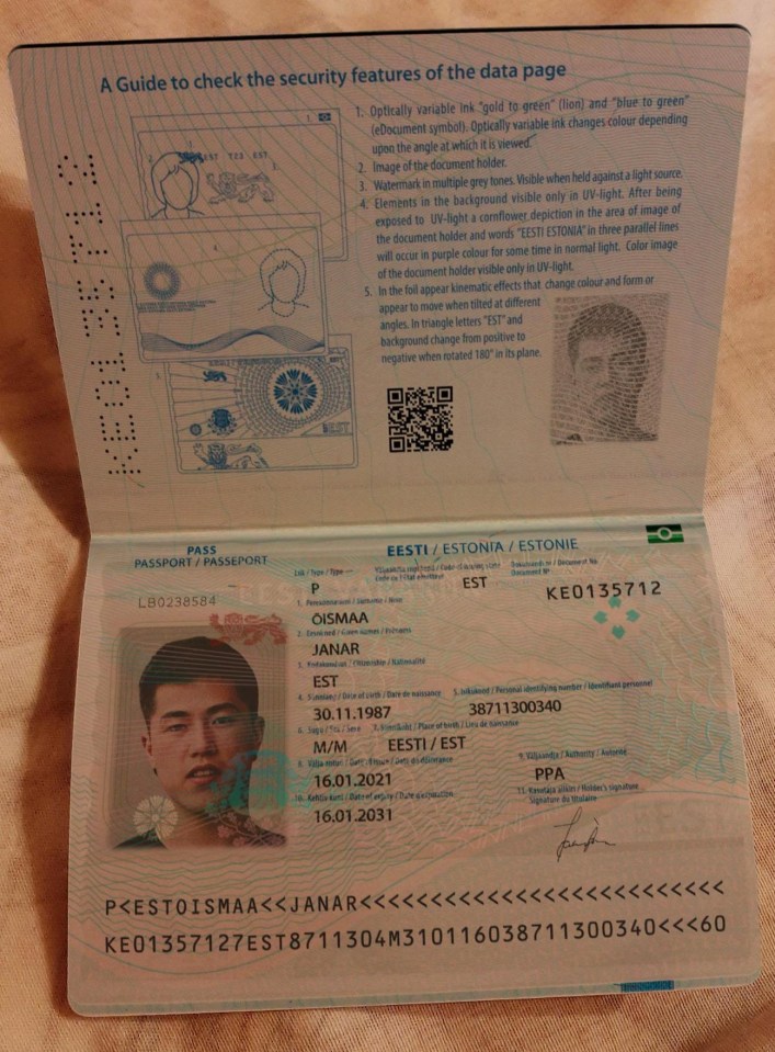 Photo of an Estonian passport's data page, showing security features and holder's information.