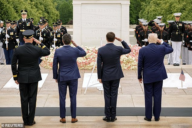 President Donald Trump (right) salutes alongside Vice President J.D. Vance (center) and Defense Secretary Pete Hegseth (center left) at Monday's Memorial Day ceremonies at Arlington National Cemetery