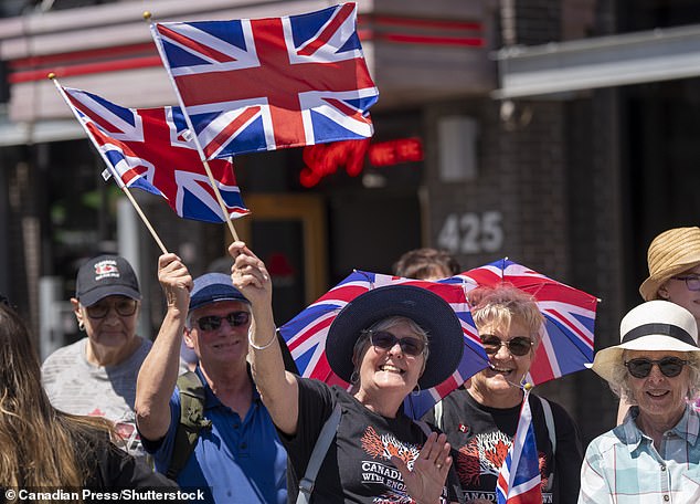 Royal fans wave as they wait for the arrival of King Charles and Queen Camilla at Lansdowne Park in Ottawa