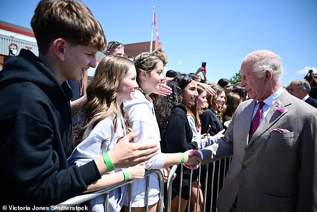 King Charles shakes hands with people waiting in Canada