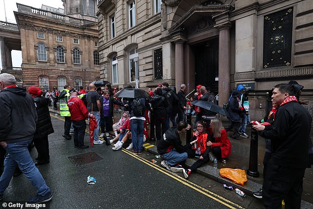 An emergency service presence is pictured as members of the public react on Water Street