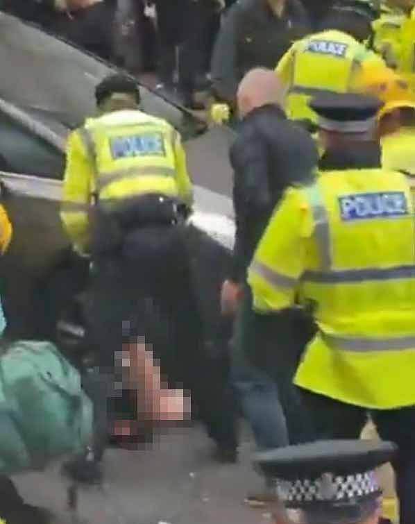 Police attend to an injured person at the scene