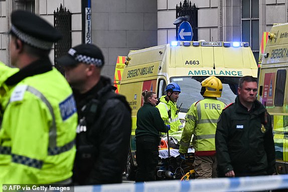 A person is evacuated on a stretcher as police and ambulance gather on the scene of an incident in Water Street, on the sidelines of an open-top bus victory parade for Liverpool's Premier League title win, in Liverpool, north-west England on May 26, 2025. A car collided with a number of pedestrians in Liverpool, northern England, on May 26 evening during Liverpool FC's Premier League victory parade, police said. Police said they were contacted shortly after 6pm (1700 GMT) 'following reports of a collision between a car and a number of pedestrians' in the city centre. One man has been arrested, according to the police, who did not say whether there were any casualties. (Photo by Paul ELLIS / AFP) (Photo by PAUL ELLIS/AFP via Getty Images)