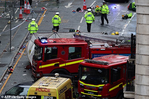 Police officers investigate the scene of an incident in Water Street, on the sidelines of an open-top bus victory parade for Liverpool's Premier League title win, in Liverpool, north-west England on May 26, 2025. (Photo by Darren Staples / AFP) (Photo by DARREN STAPLES/AFP via Getty Images)