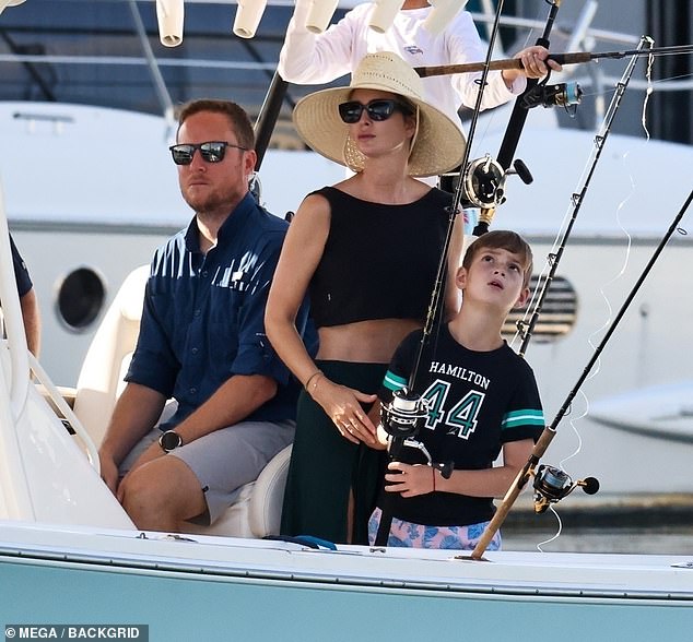The mother-of-three was spotted helping her kids fish during the boat ride