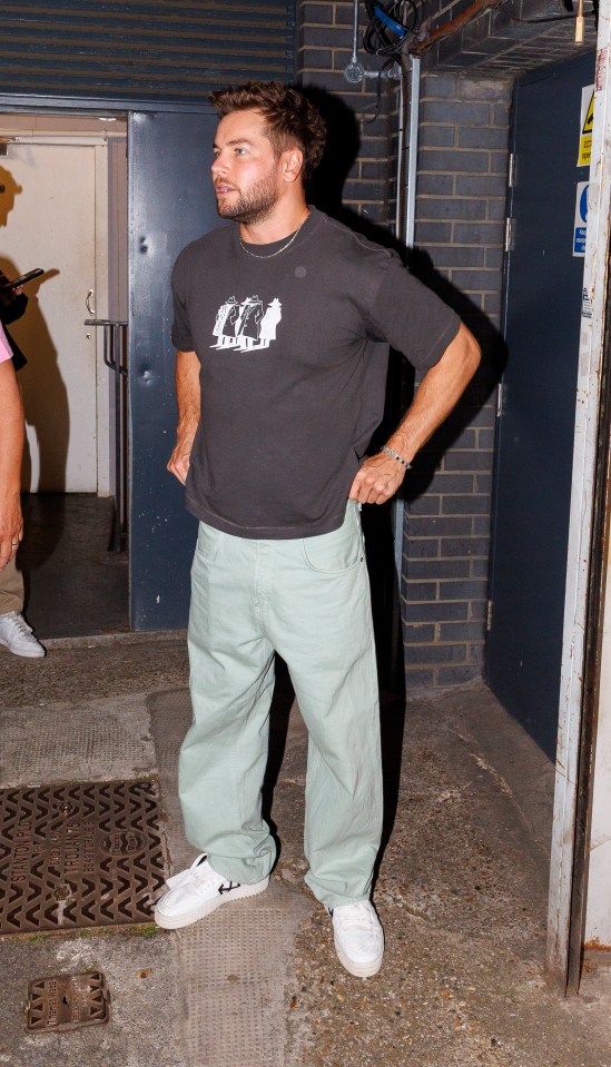 Chris Hughes leaving a building.