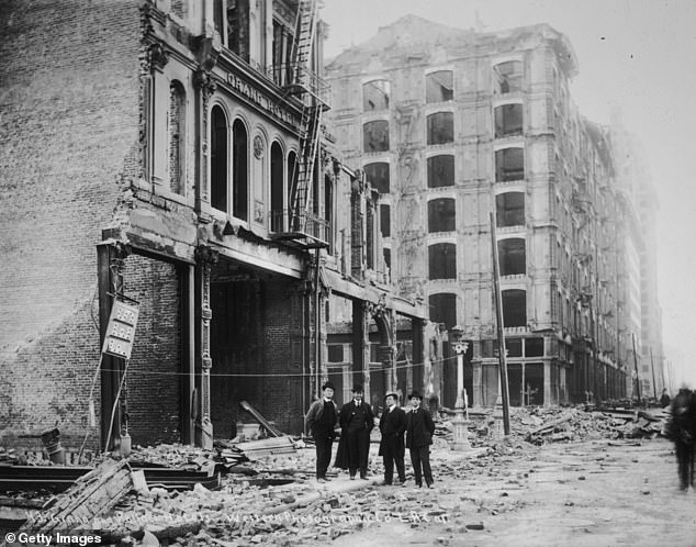 Survivors view the wreckage of the Grand and Palace Hotel after the 1906 earthquake in San Francisco, which leveled 80 percent of the city's buildings