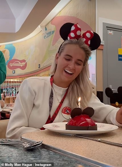 She later enjoyed a Mickey Mouse shaped cake with a candle to celebrate her birthday as they stopped for lunch during their fun-filled day in the theme park