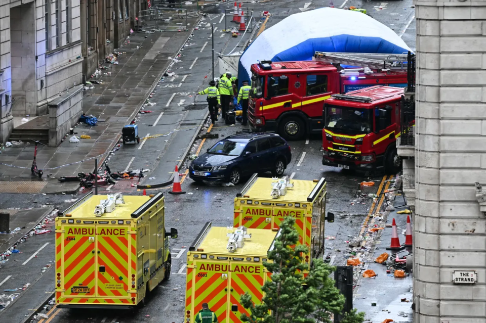 Emergency vehicles and debris in a city street.