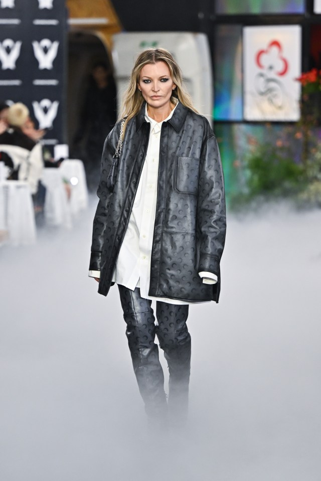 Model walking a runway at Paris Fashion Week.