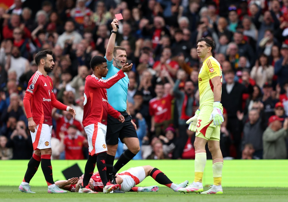 Referee showing a red card to a soccer player.