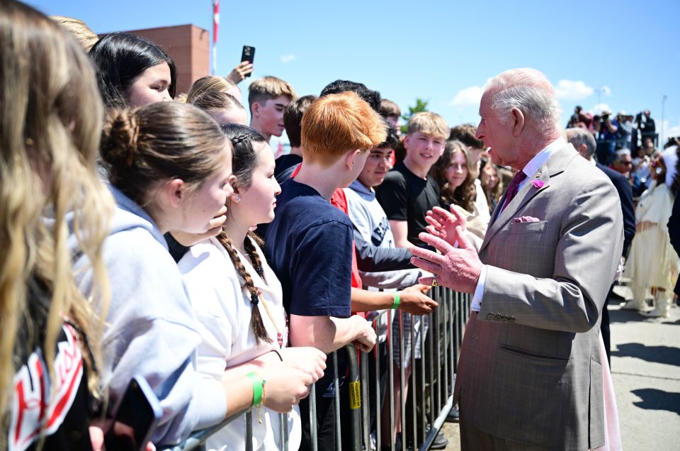 King Charles III greeting school children.