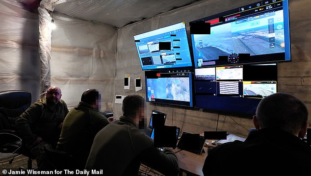 Major Anatolii, left, in his underground bunker, from which he and his men are defending their homeland