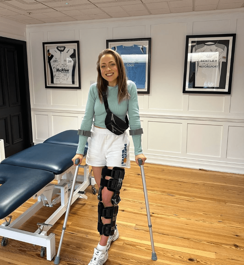 Woman with leg brace and crutches.