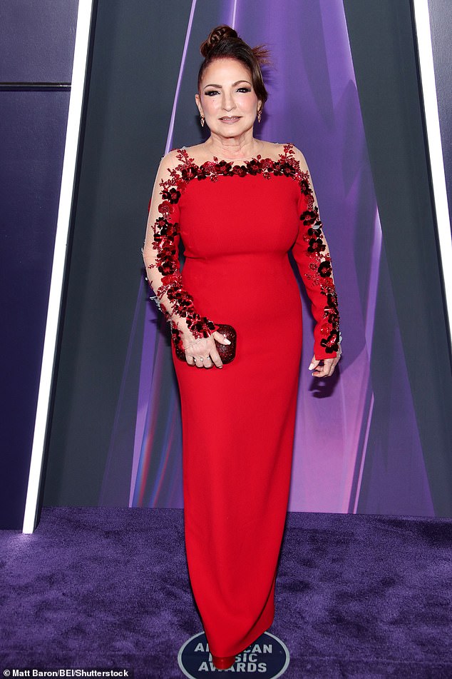 The songstress - who is known as the Queen of Latin Pop - also carried a glittering dark red clutch to hold a few items she needed for the ceremony