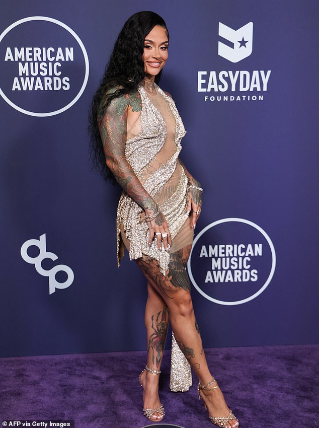 The halter-styled outfit contained a longer strip of sparkling fabric on the left side that fell down towards the ground