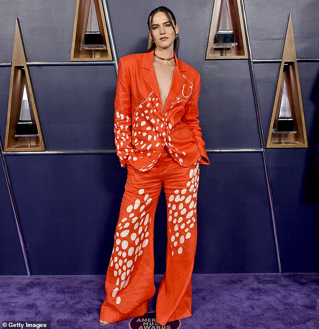 Sophie Hawley-Weld of musical duo Sofi Tukker donned a colorful outfit which comprised of a vibrant orange blazer and matching, loose-fitting trousers with a white pattern