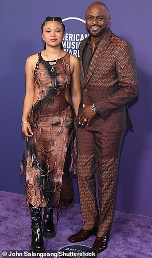 Wayne Brady was dapper in a brown-patterned suit which was paired with a black shirt as well as shiny brown loafers