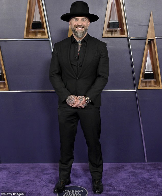 The singer added a black hat on top of his head and also donned a pair of sleek black dress shoes