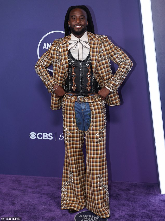 Shaboozey showed off his personal sense of style wearing a colorful plaid suit jacket as well as matching chaps over denim jeans from ETRO.