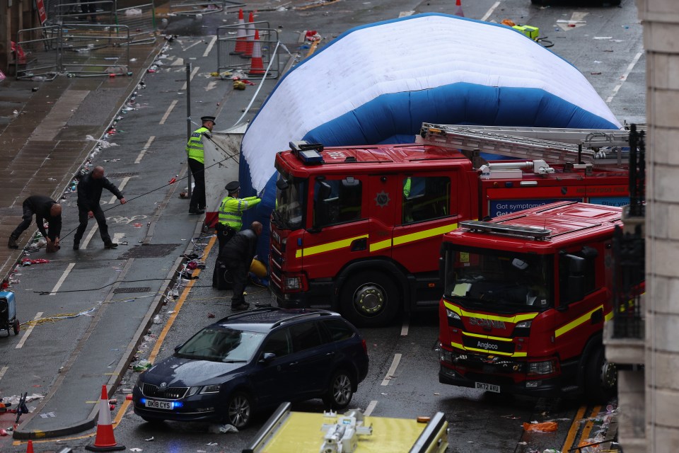 Aftermath of a car collision with pedestrians during a parade.