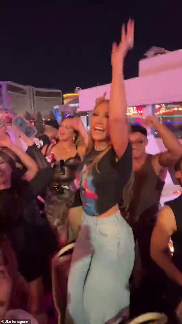 After declaring she's excited to have a 'free and happy' summer, the A-list flashed her toned torso in a cropped graphic T-shirt and low-rise jeans as she partied without a care in the world
