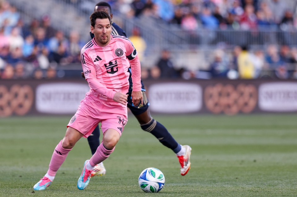 Lionel Messi dribbling the ball during a soccer game.
