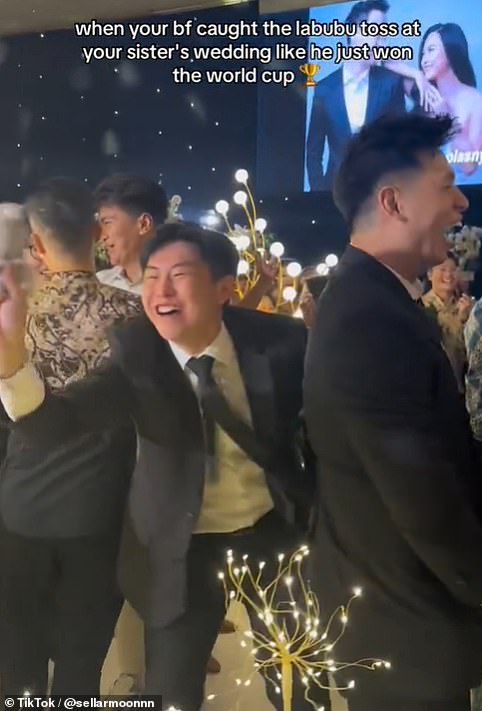 An unamed man appeared delighted as he won a Labubu when the bride and groom tossed it at their wedding