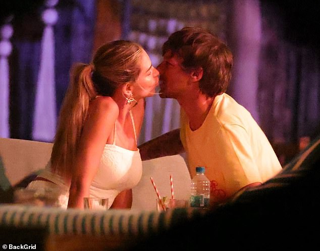 The Love Island star, 28, who was reportedly flown out first class by the One Direction star, 33, was spotted locking lips with her new man at the modest Banana Beach Restaurant which overlooks the ocean