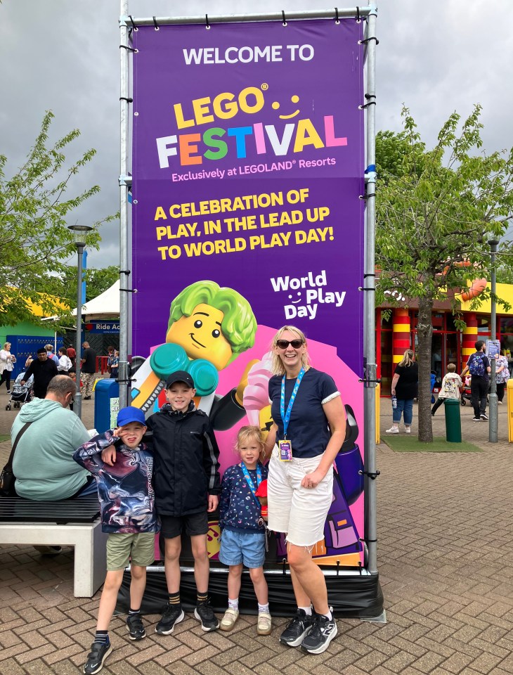 Family posing with a Legoland Festival sign.