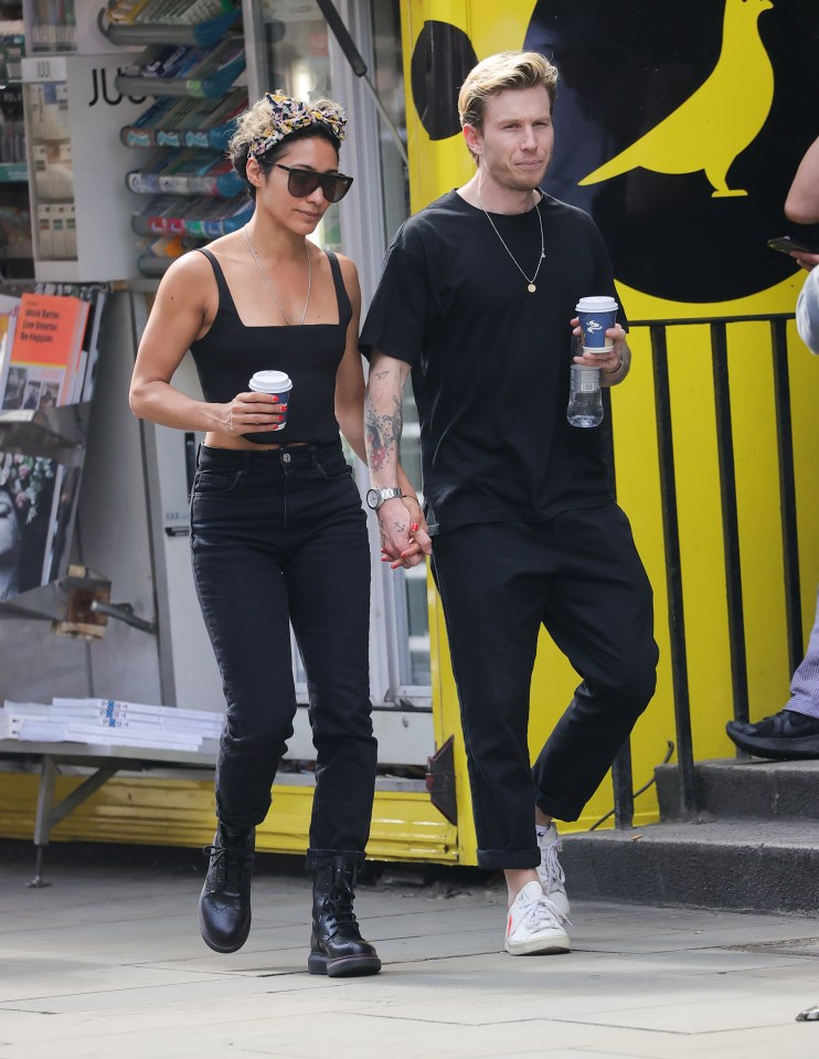 Karen Hauer and Jordan Jones Williams holding hands and walking down the street.