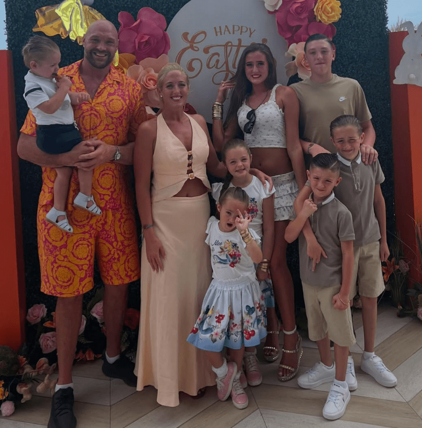 Family portrait in front of a Happy Easter sign.