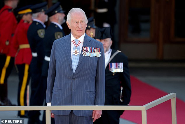 The King stood outside the Senate of Canada Building while a band played the Canadian national anthem