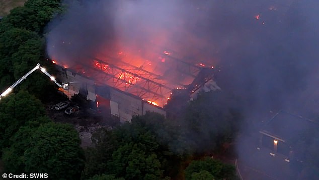 Drone footage shows how a large door on an aircraft hangar at the ex-RAF base collapsed in the inferno