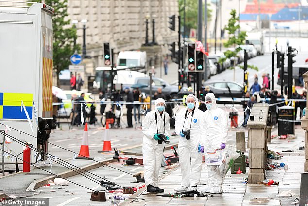 Forensic officers by the scene of the incident on Water Street in Liverpool city centre today