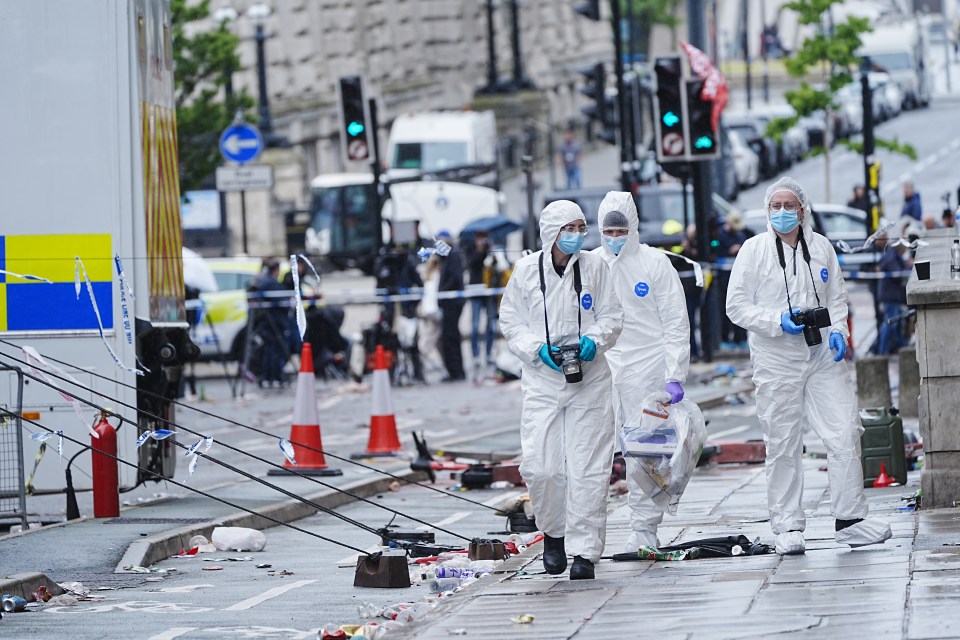 Forensic officers collecting evidence at a crime scene.