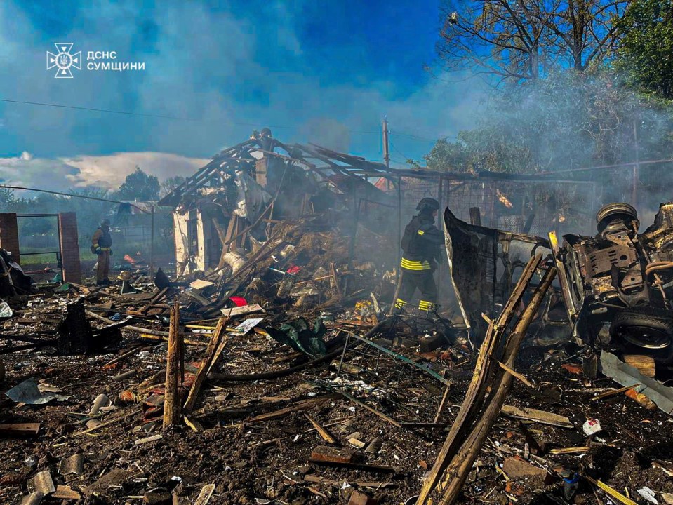 Firefighters extinguishing a fire at a destroyed building in Bilopillya, Ukraine.