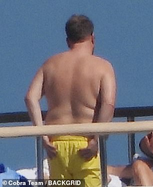 The actor, comedian and presenter sported a pair of canary yellow beach shorts as he relaxed on Sunday