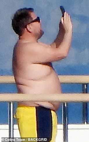 The presenter was seen taking photos on his mobile phone while cruising the Mediterranean
