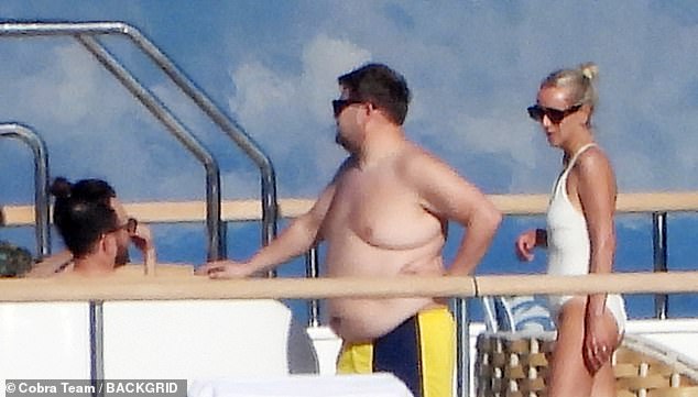 Joining her husband, Julia caught the eye in a plunging white swimsuit as they idled on the boat's top deck