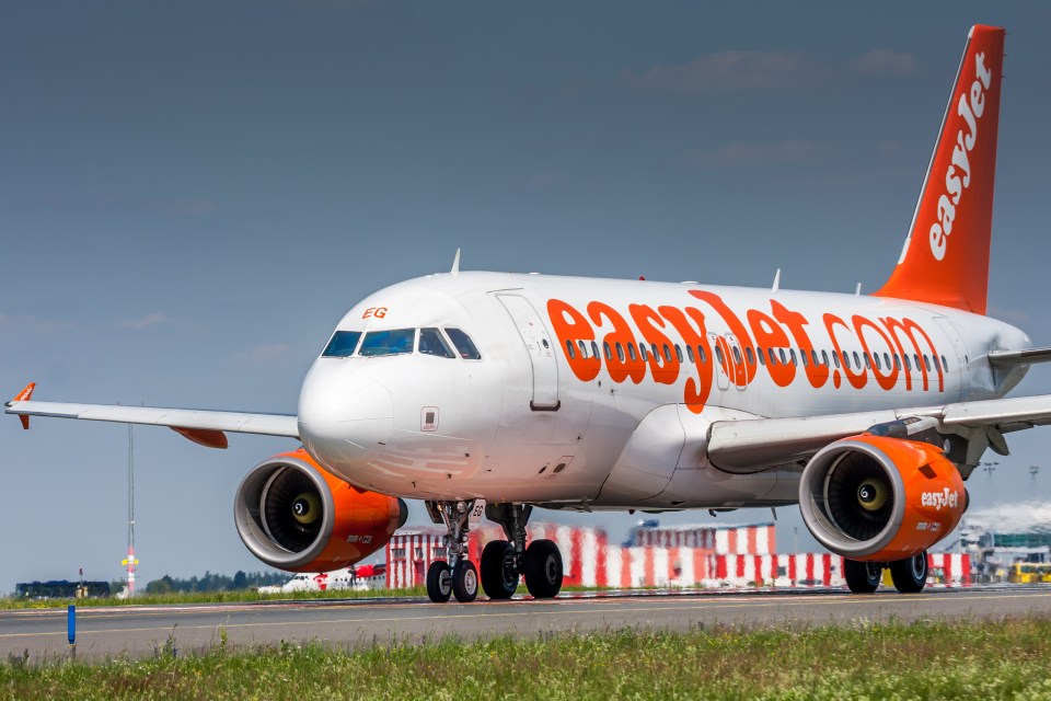 EasyJet Airbus A320 taxiing on an airport runway.
