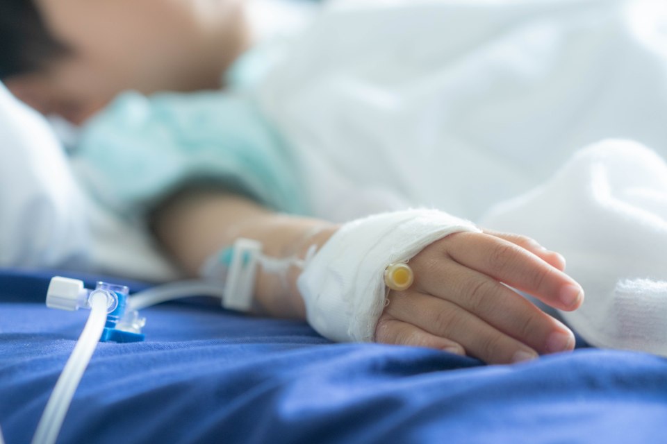 Toddler in hospital with IV saline drip.